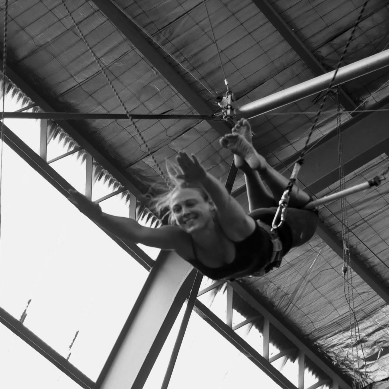 LJ Fryer hanging from trapeze